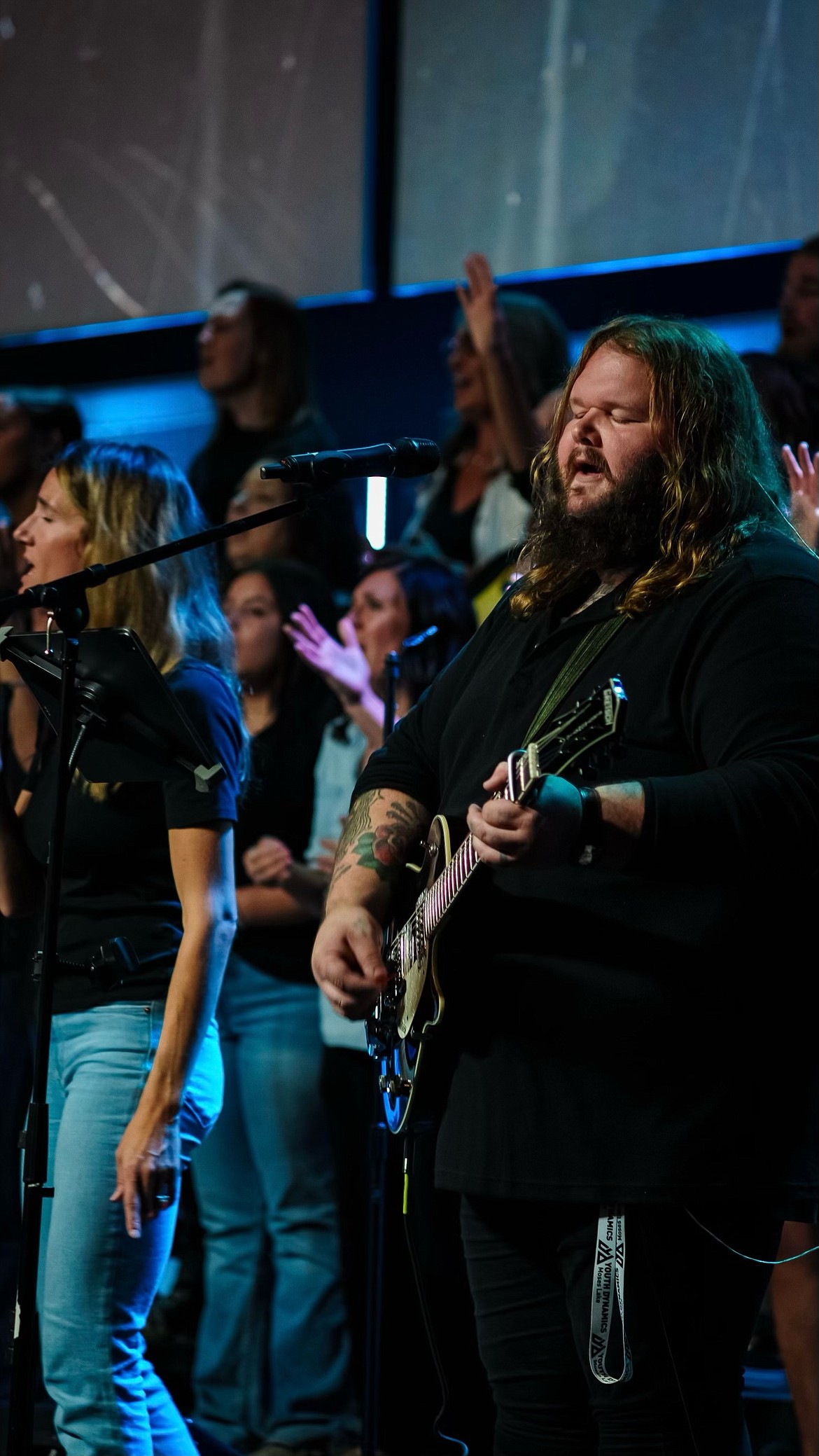 Campus Coordinator at Youth Dynamics and Worship Leader at Grace Harvest Church Davie Sawyer plays the guitar during the United Community Worship Night at Restore City Church Friday.
