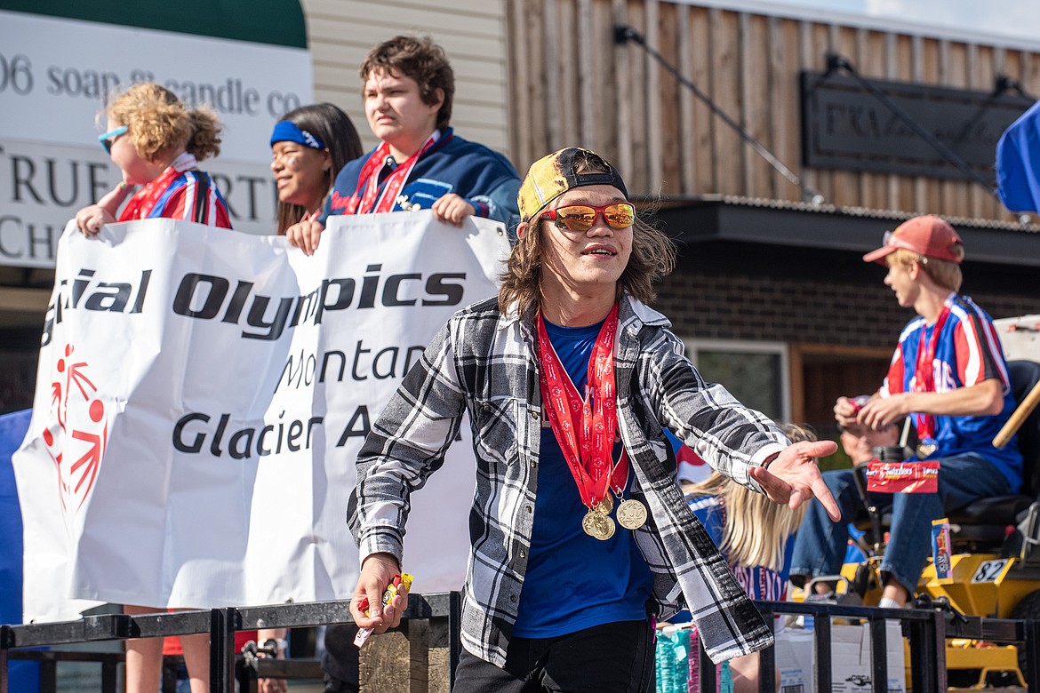 Chris Reile tosses candy for the Special Olympics Montana float in the Wildcats Homecoming Parade on Wednesday.