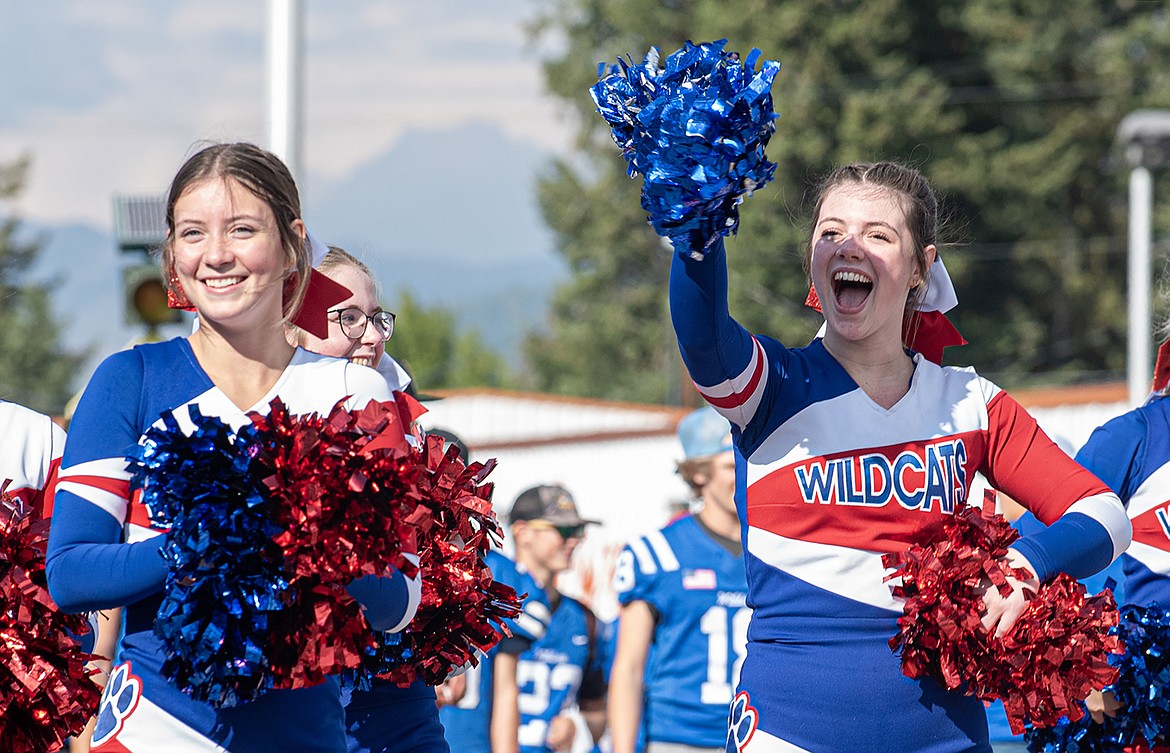 Wildcats cheerleaders Aliyah Arends and Tabatha Smalley smile to the spectators at the Homecoming Parade on Nucleus Avenue Wednesday, Sept. 20.