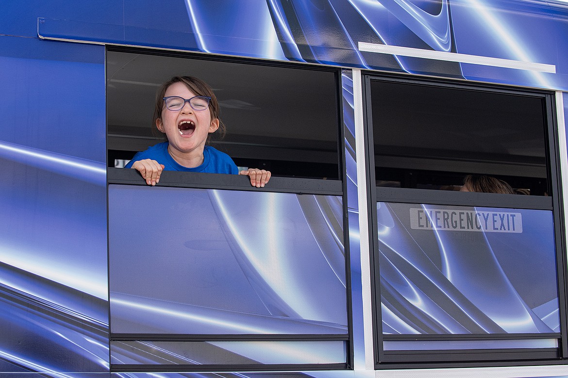 A youngster screams, “Go Wildcats!” from the last entry in the Wildcats Homecoming Parade on Wednesday.