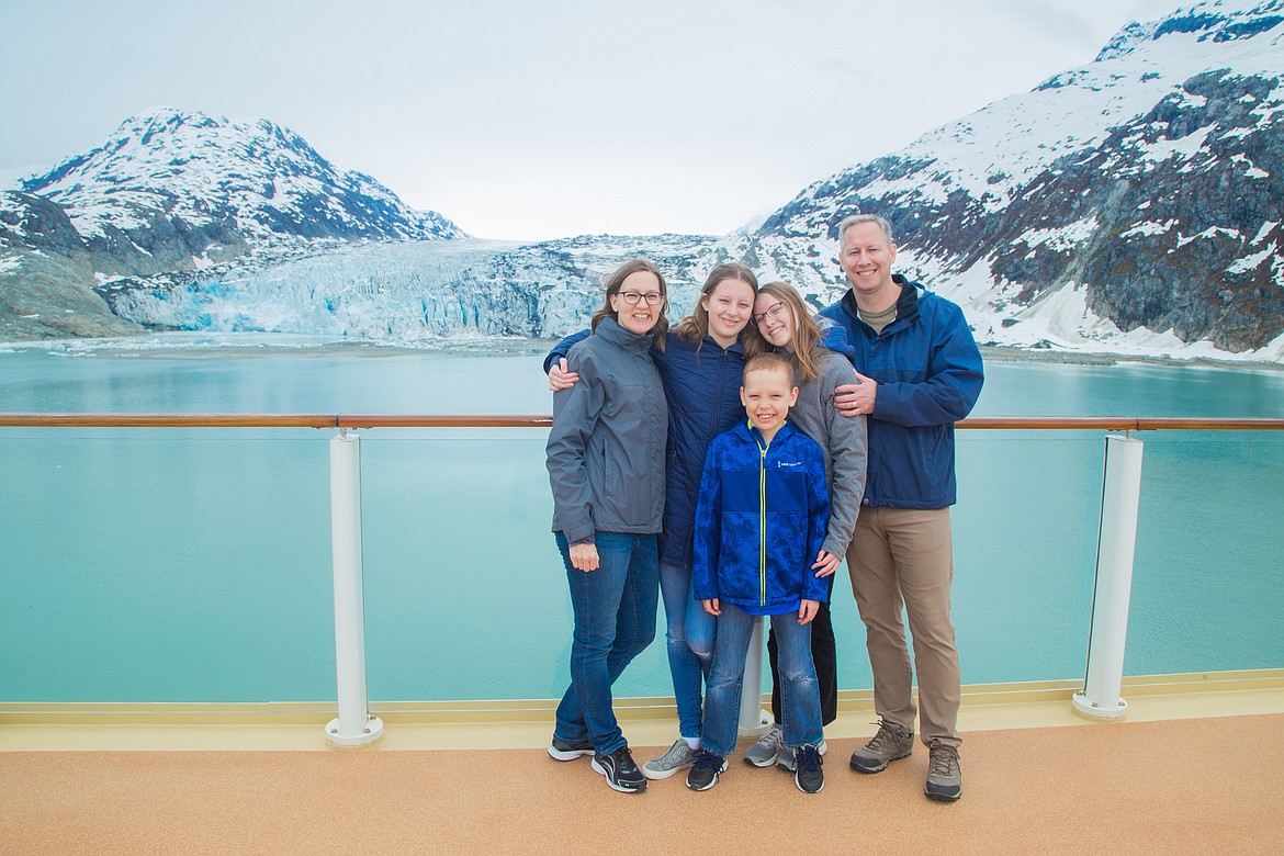 Moses Lake-raised author A.L. Sowards, left, stands in front of a glacier with her husband, right, and their three children.