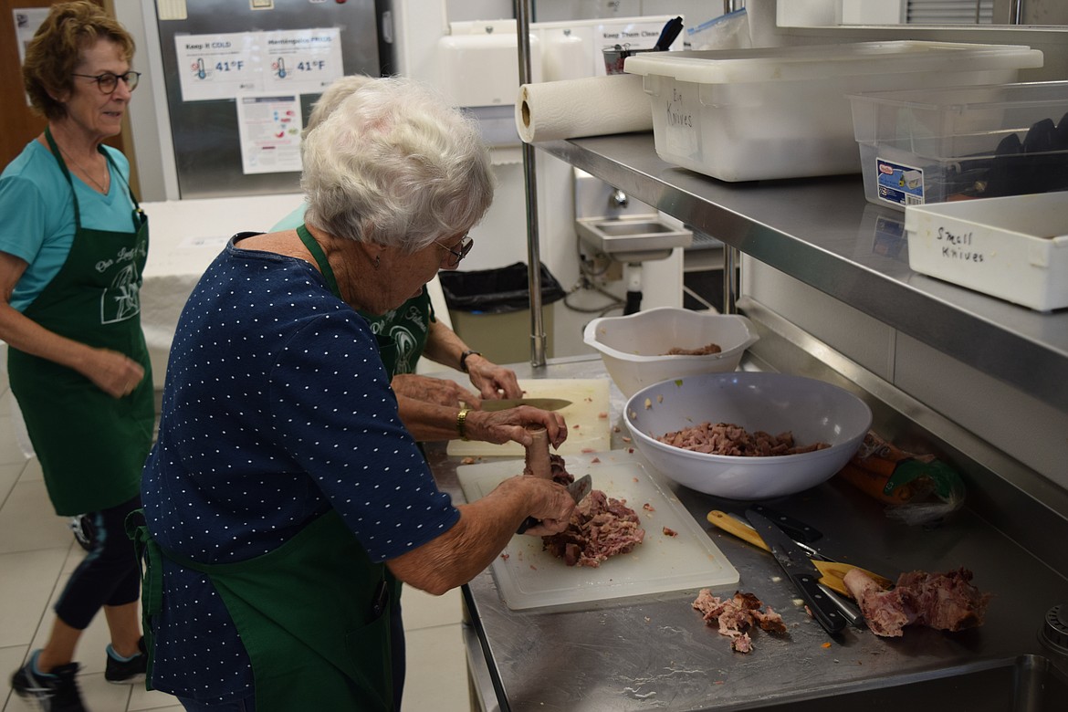 Soup Kitchen team members prepare the ham and potato soup for the Sept. 7 Thursday free hot lunch at Our Lady of Fatima Catholic Church.