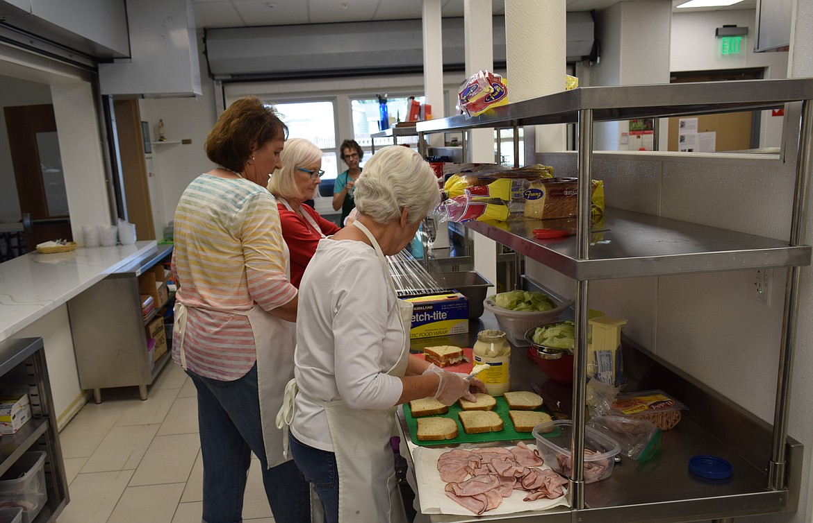 Soup Kitchen volunteers prepare sandwiches to go with the soup for the Sept. 7 Thursday lunch.