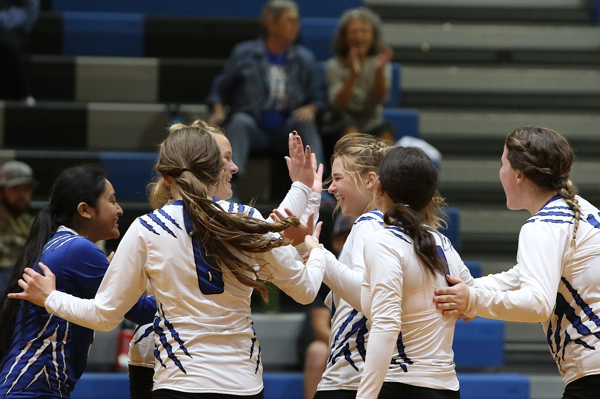 Soap Lake players celebrate after a point in Tuesday night’s sweep of Cascade Christian.