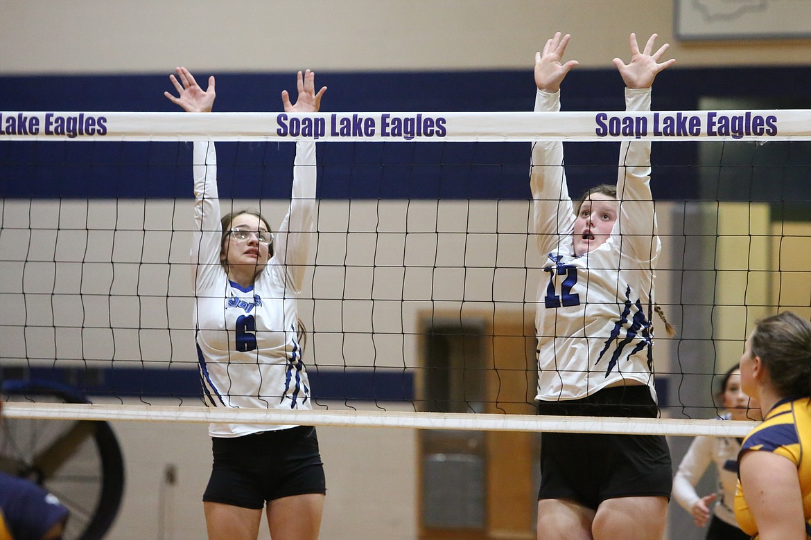 Soap Lake sophomores Tanya Zubritskiy and Brooke Dana jump up to attempt a block against Cascade Christian on Tuesday.