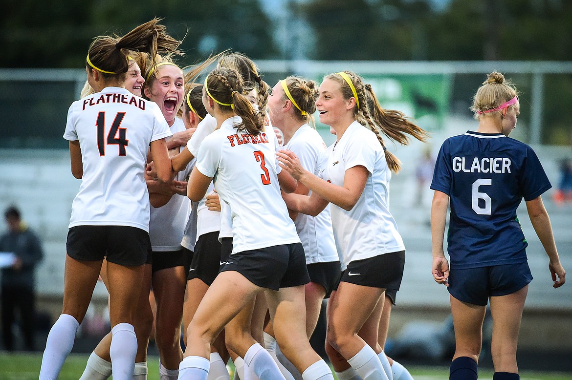 The Bravettes celebrate around Azalea Bailey (24) after her goal in the second half against Glacier at Legends Stadium on Thursday, Sept. 21. (Casey Kreider/Daily Inter Lake)