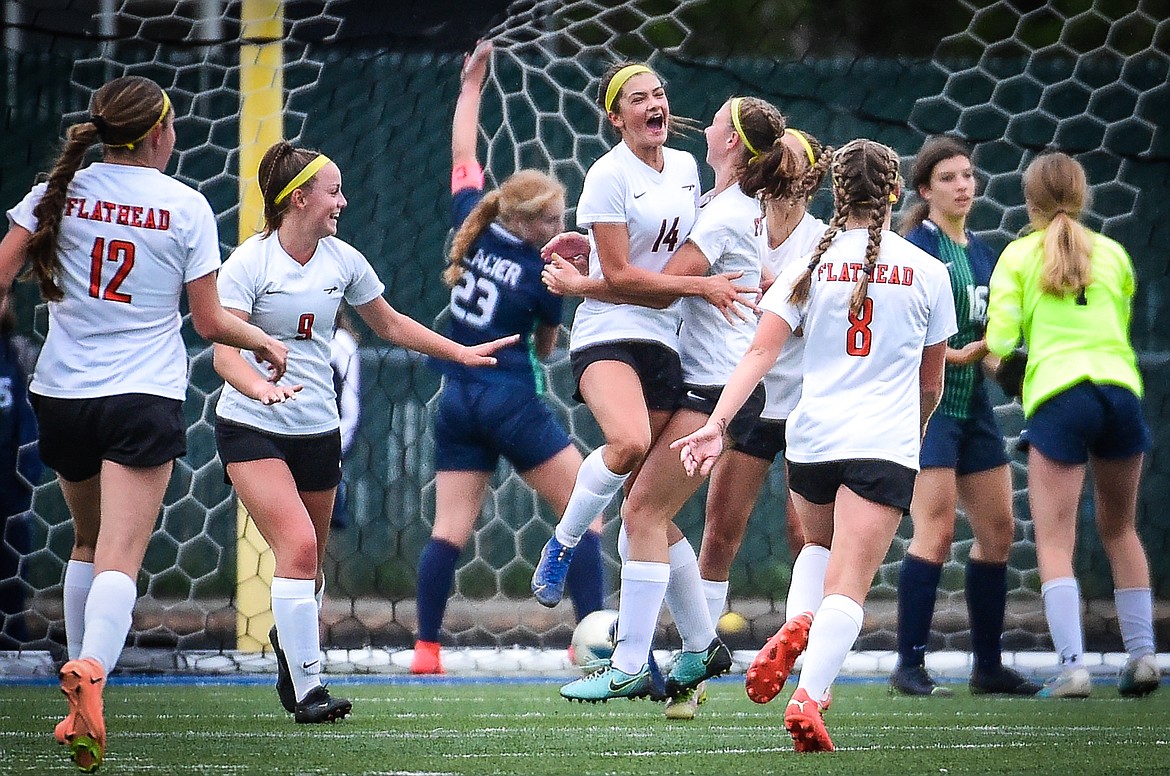 The Bravettes celebrate around Avi Schmautz (14) after her goal in the first half against Glacier at Legends Stadium on Thursday, Sept. 21. (Casey Kreider/Daily Inter Lake)