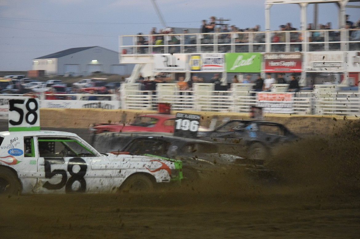 Othello Demolition Derby racers slam into each other as mud flies during the heat races at the Sept. 13 event.