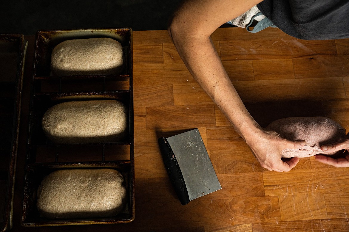 Caroline Garrett readies loaves of bread. (Photo courtesy of Kyle Stansbury Photography)