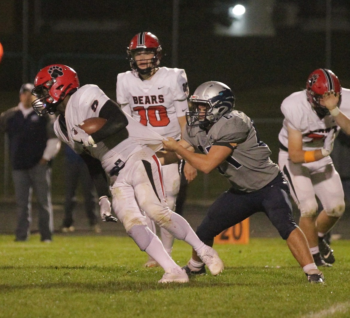 MARK NELKE/Press
Austin Leighton, right, of Lake City, drags down Eby Qualls of Moscow in the second half Friday night at Lake City.