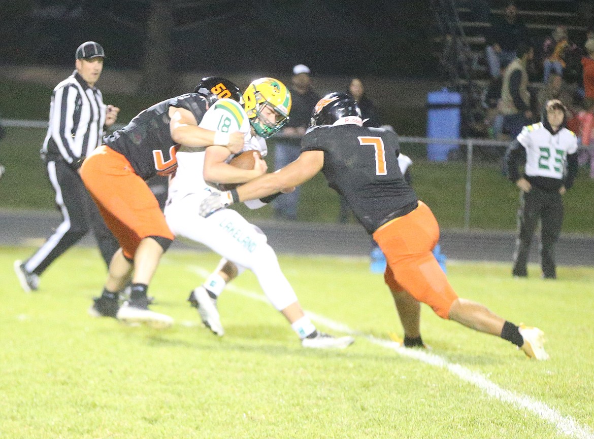 JASON ELLIOTT/Press
Post Falls senior defensive lineman Hayden Meyer (50) and senior linebacker Cooper Craig (7) sack Lakeland sophomore quarterback Peyton Hillman during the third quarter of Friday's game.