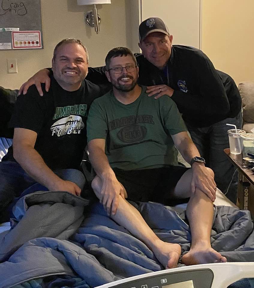 Photo courtesy of BRYAN CHASE
St. Maries boys basketball and golf coach Bryan Chase, former St. Maries football and baseball coach Craig Tefft (center) and former football and baseball asssistant coach Chase Bennett (right) watch the Lumberjacks' Sept. 15 game at the Schneidmiller Hospice House in Hayden. Tefft, 47, passed away after a 10-month battle with colon cancer on Tuesday.