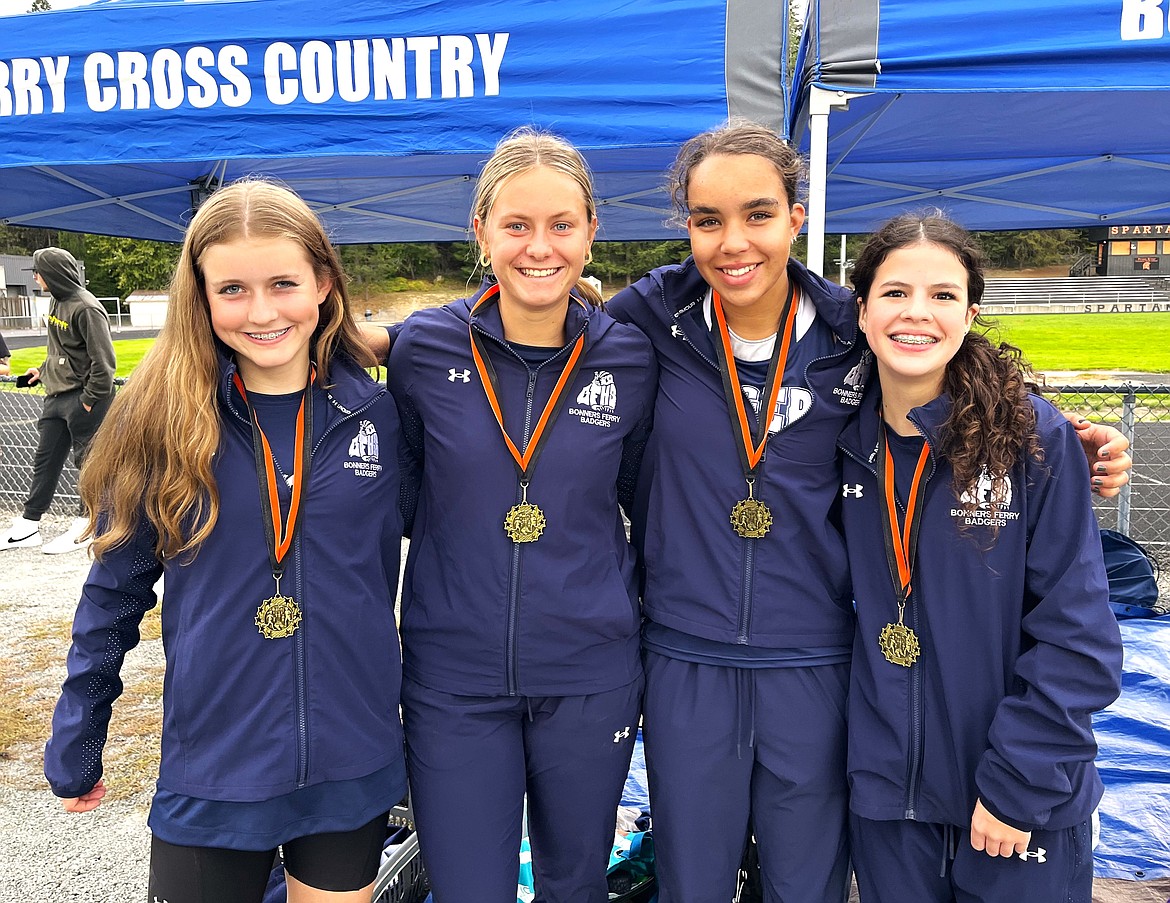 Badger girls cross country top 10 finishes with their medals (left) Ruby Law, Braylyn Bayer, Mati Stiern and Sydney Beckle.