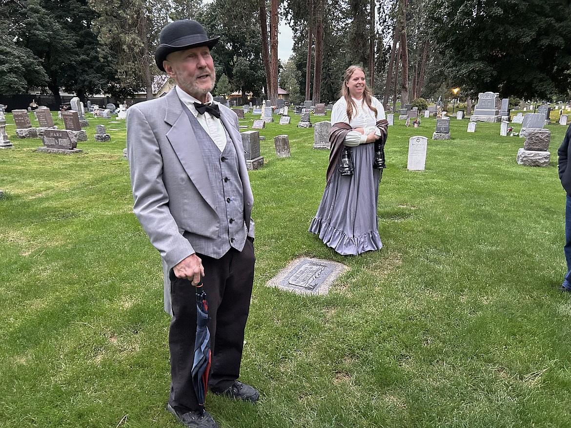 Dave Eubanks and Jordan Thomas lead the walking tour at Forest Cemetery Friday.