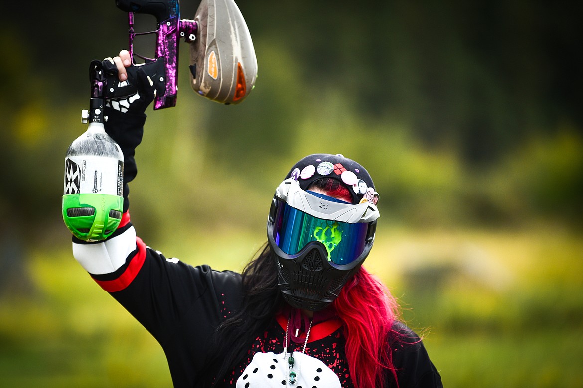 A player raises her arm and gun over her head to signify she's been shot during a game of five-on-five at Montana Action Paintball near Kila on Saturday, Sept. 23. (Casey Kreider/Daily Inter Lake)