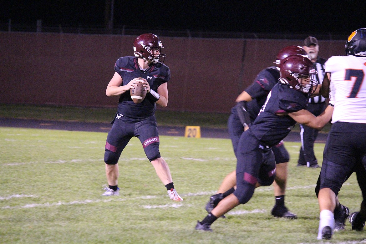 Wahluke quarterback Andrew Yorgeson (7) goes back to pass during the Wahluke-Zillah game Friday.