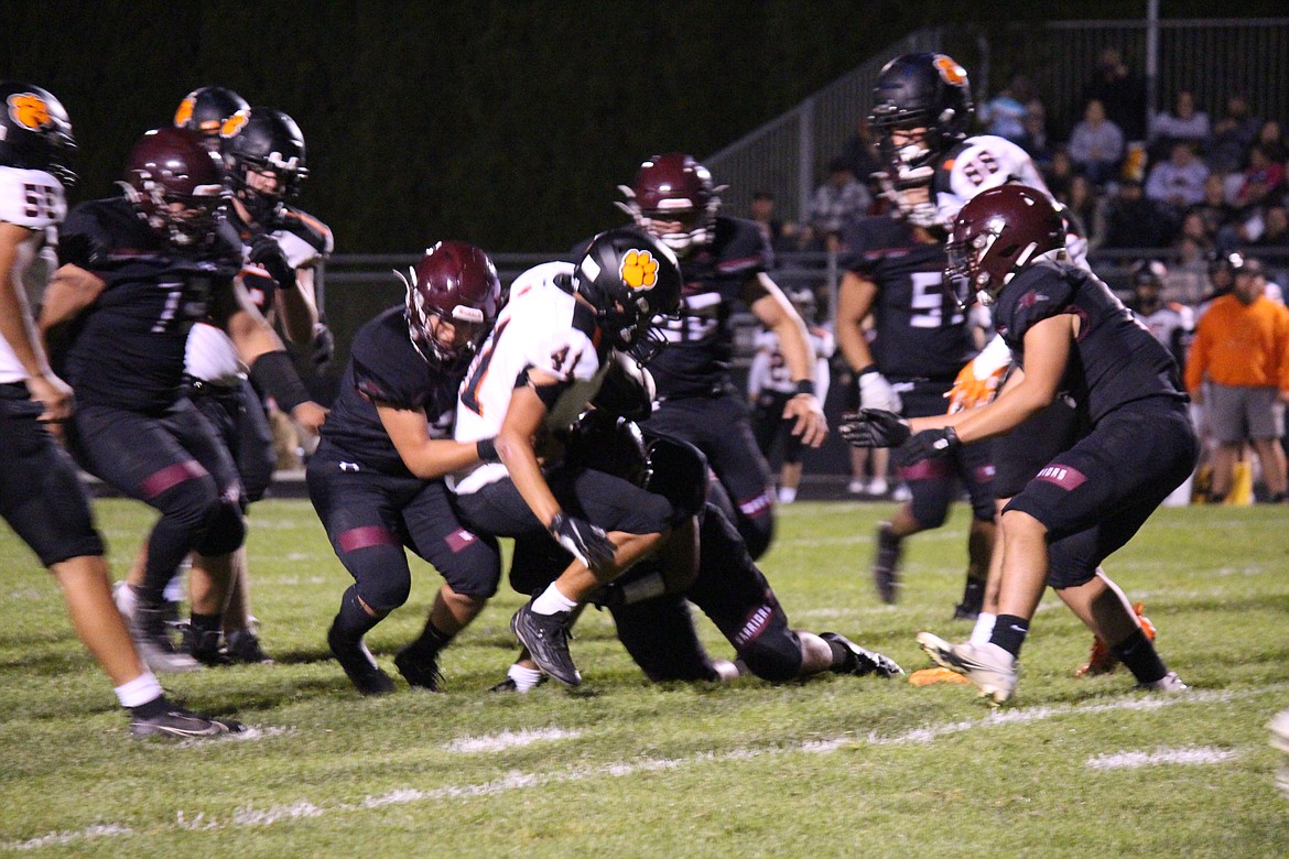 A Zillah runner goes down in the arms of the Wahluke defense in the Warriors-Leopards game Friday.