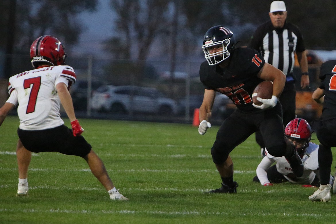 Ephrata senior tight end Eric O’Neel (11) keeps his eyes on an East Valley (Yakima) defender after a reception in the first quarter of Friday night’s win over the Red Devils.