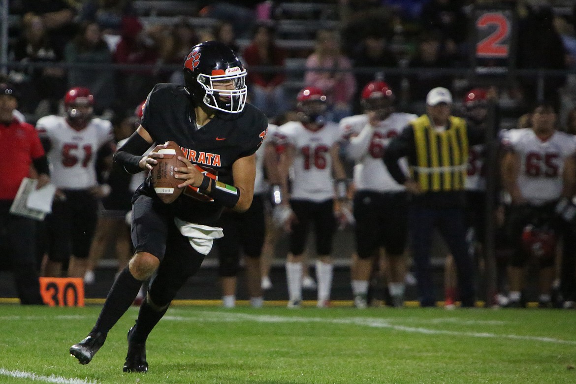 Ephrata sophomore quarterback Brady Hendrick rolls out to his right in Friday’s 21-17 win over East Valley (Yakima).