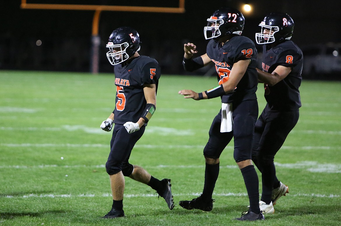 Ephrata senior Walker Fulk (5) celebrates with teammates Brady Hendrick (12) and Calvin Lybbert (8) after Fulk intercepted an East Valley pass.