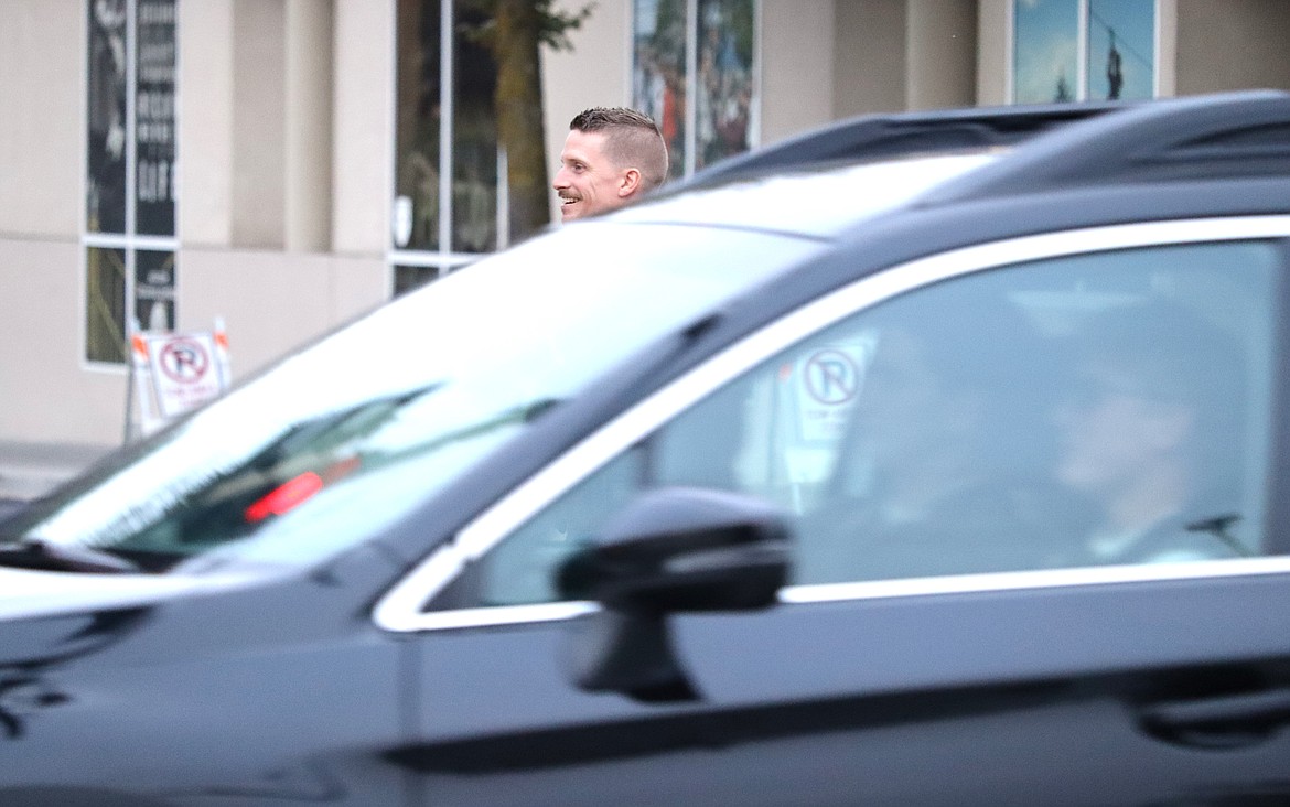 Coeur d'Alene Police Officer Derrick Vachon looks up Sherman Avenue as a vehicle passes by on Sherman Avenue.