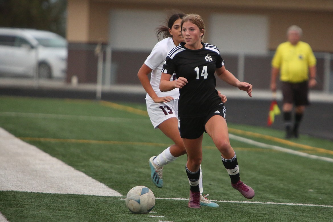 Royal freshman Maggie Frank (14) pushes the ball upfield against Wahluke on Thursday.