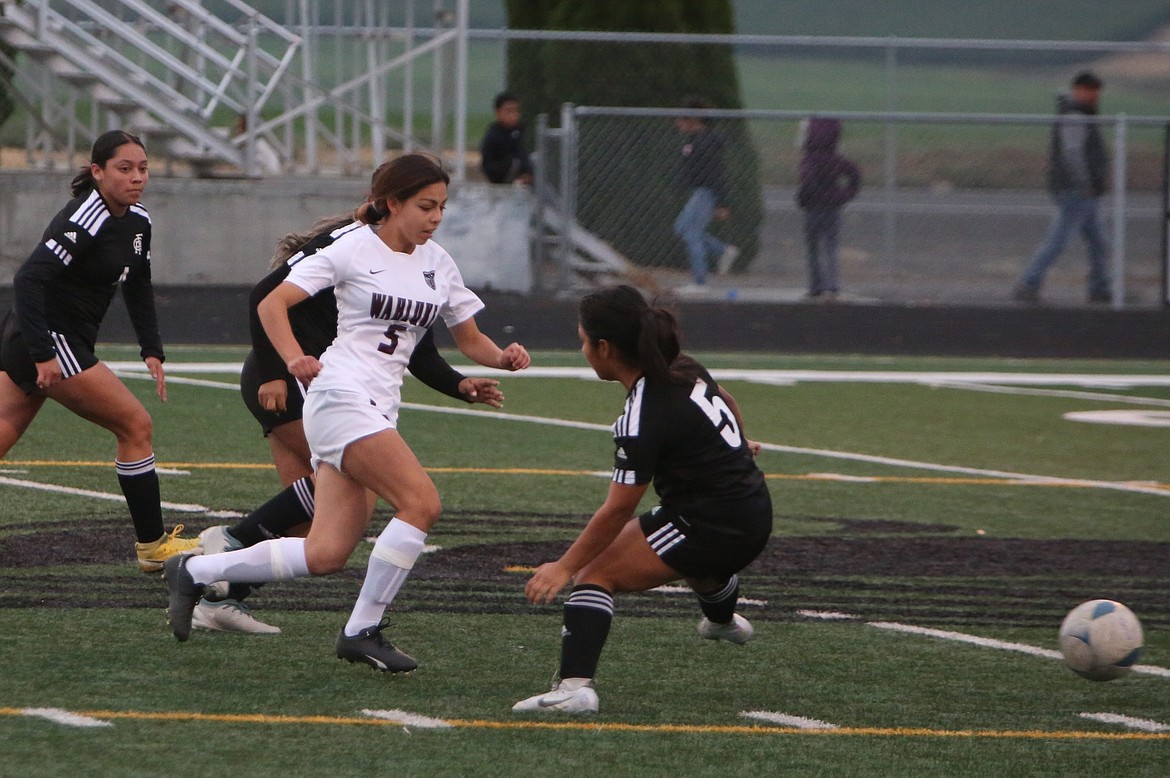 Wahluke sophomore Lorraine Badillo (5) runs past Royal defenders in the first half of Thursday’s match.