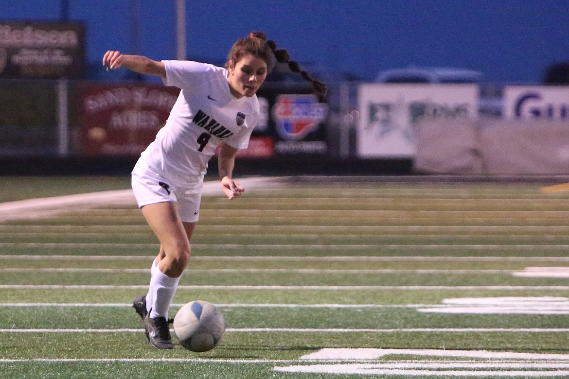 Wahluke senior Angelica Fabela keeps her eyes on the ball while making a move in the second half against Royal.