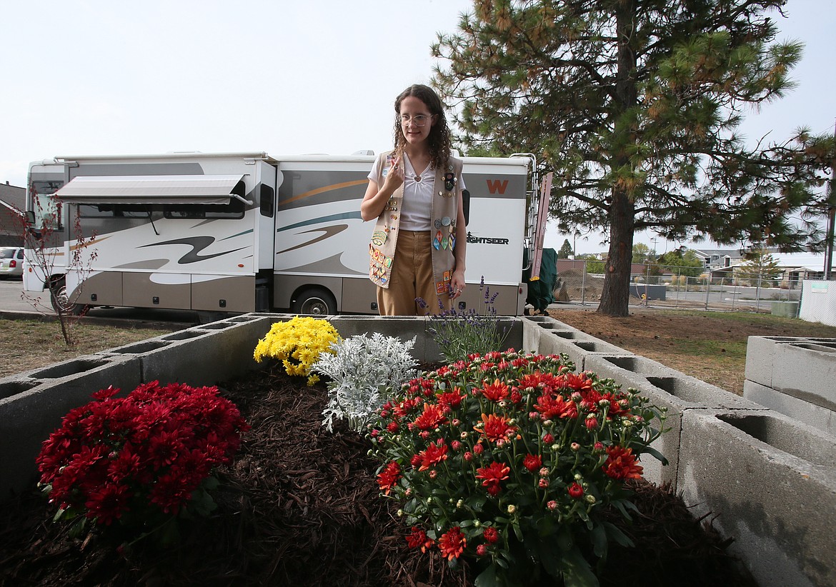 Girl Scout Sierra Livingston, 18, of Post Falls, looks over a newly. constructed raised flower bed Sunday at the Post Falls VFW. Livingston and her crew installed two raised beds, a bird bath and a flag drop receptacle and they landscaped a portion of the land as part of her Girl Scout Gold Award project.