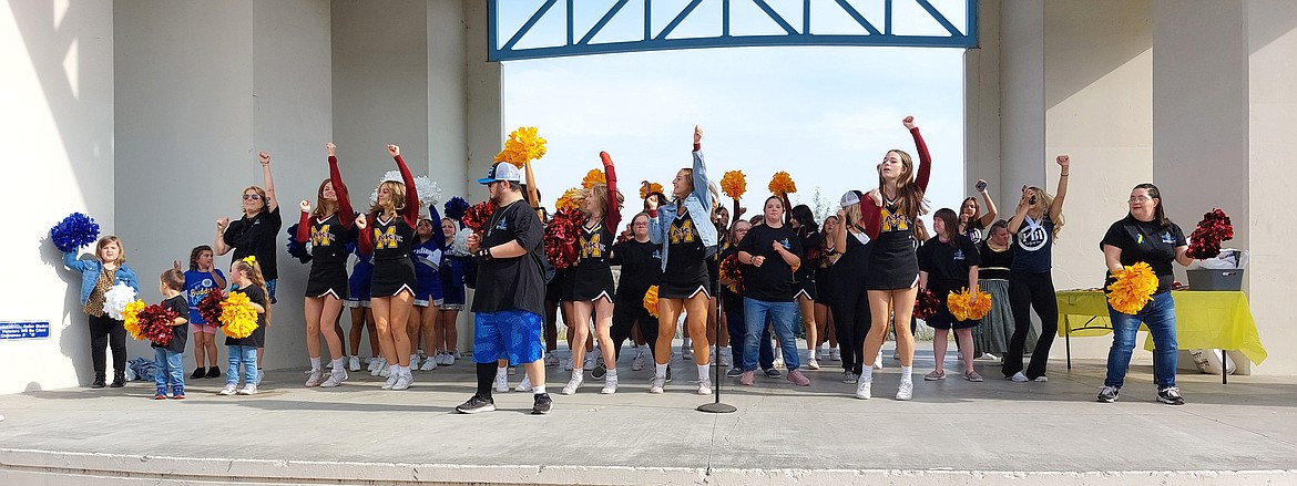 People with Down syndrome rock out at the Centennial Amphitheater before the 11th annual Buddy Walk, accompanied by family, friends and the Moses Lake High School cheerleaders.