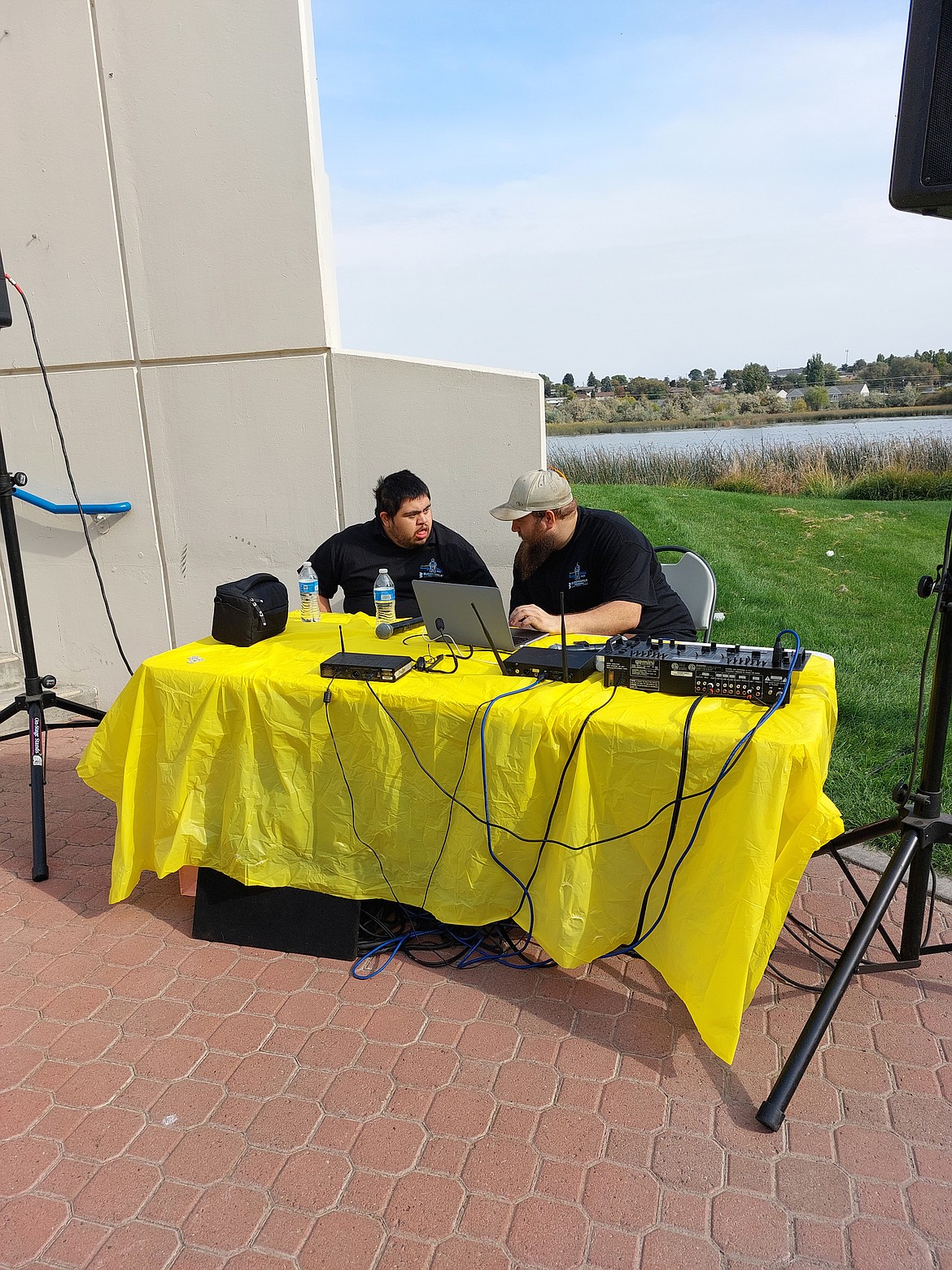 Brandon Rodriguez, left, talks with his former classmate Kevin Duggan, who was handling sound at the Buddy Walk Saturday.