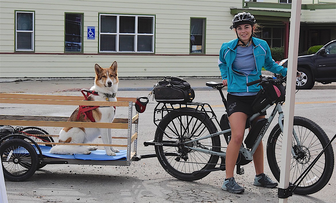 MMAPP cyclist Teagan Halloran and her dog Miska finish the ride on Ronan's Main Street on Saturday. (Berl Tiskus/Leader)