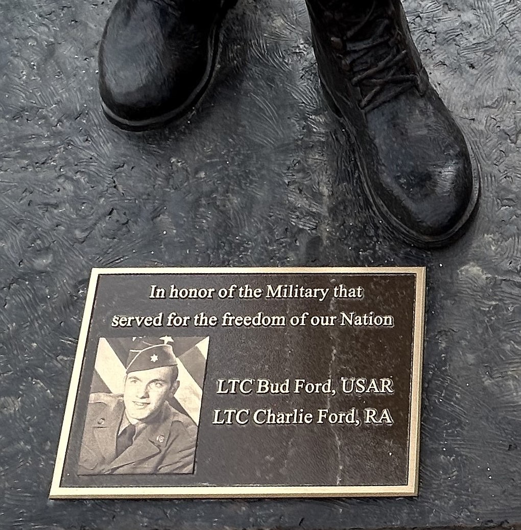 A plaque is at the feet of the bronze statue depicting a World War II Army soldier at McEuen Park Veterans Memorial Plaza on Monday.