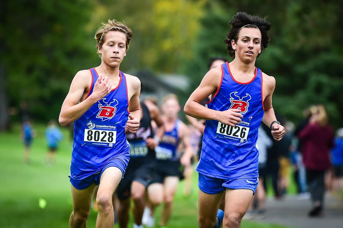 Bigfork's Noah Hamilton-Dixon and Sean Cotman run the course during the Whitefish Invite at Whitefish Lake Golf Club on Tuesday, Sept. 26. (Casey Kreider/Daily Inter Lake)