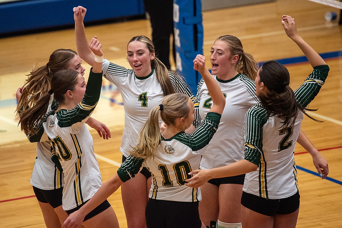 Myli Ridgeway (4), Brooke Zetooney (22) and their teammates celebrate scoring on the Columbia Falls Wildkats on Thursday, Sept. 21. The Bulldogs won the match in four sets. (Avery Howe/Hungry Horse News)