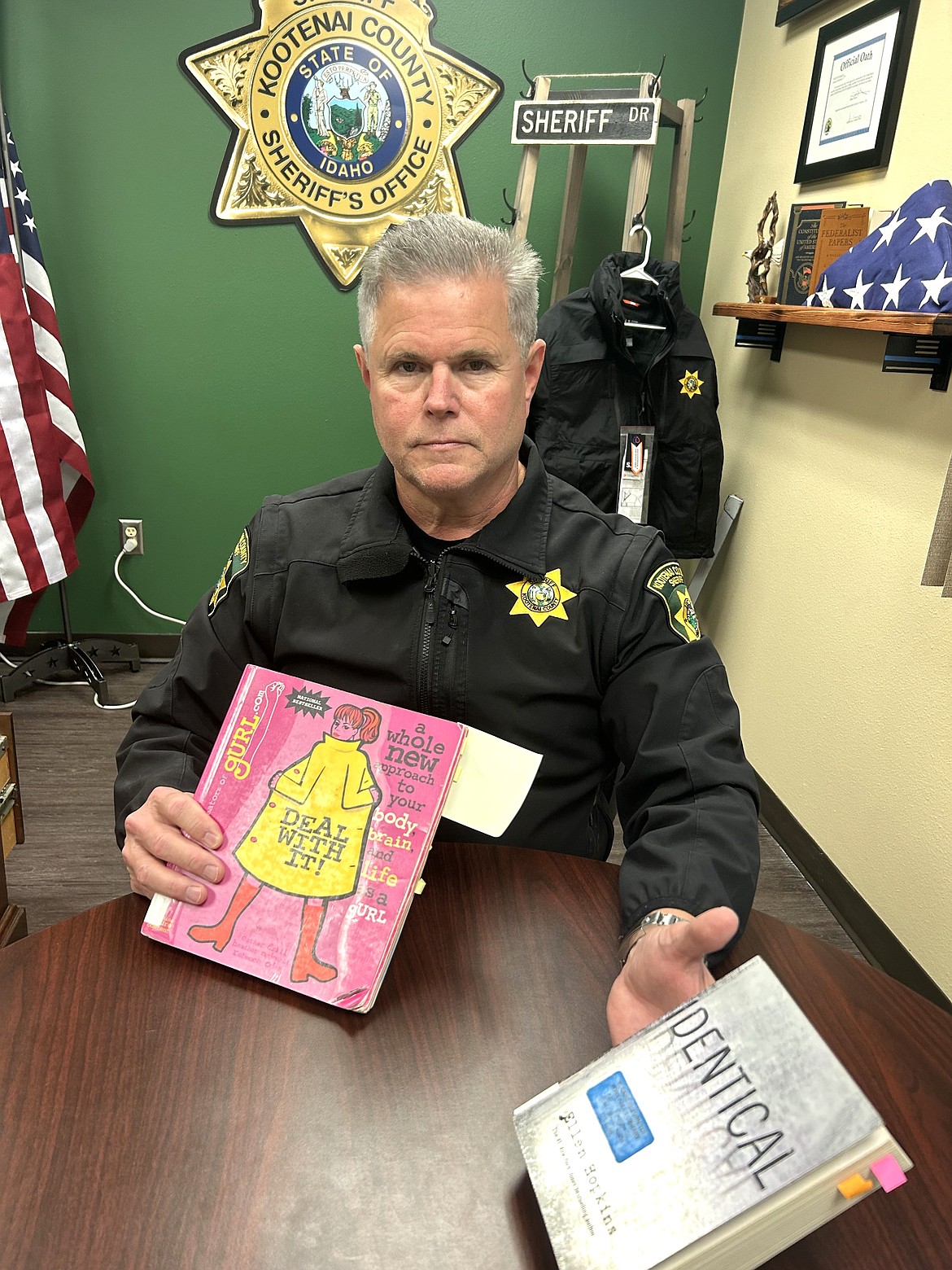 Kootenai County Sheriff Bob Norris displays two books from the Post Falls Public Library that he said have sexually explicit material.