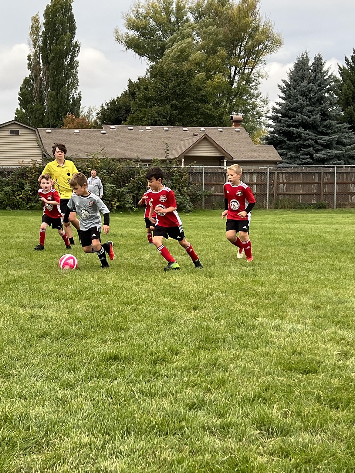 Photo by KATHY STERLING
The Timbers North FC 2016 Boys Red team played an interclub match against the Timbers North FC 2016 Black team on Sept. 22. Red won 7-4. Red goals were scored by Jackson Martin (4) and Colin Happeny (3). Black goals were scored by Mitchell Volland (2) Elijah Cline (1) and Leo Leferink (1). Pictured is Mitchell Volland in grey jersey on the Black team taking the ball to the goal with Red Team in the red jerseys from left to right, Colin Happeny, Xavier Sousley, Ben Cesarini and Isaak Sterling. On Sept. 23, the Timbers North FC 2016 Boys Red Team beat the Spokane Sounders B2016 North Blue 9-1. Red goals were scored by Jackson Martin (3), Colin Happeny (2) and Emmett Cowan (3).