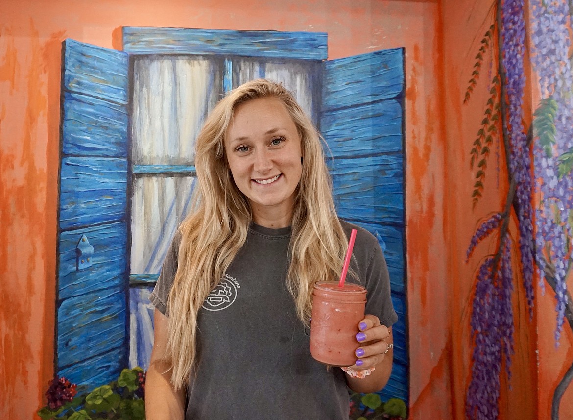 Madisen Duty, owner of Huck’s Place in Whitefish, holds a watermelon burst smoothie. The eatery focuses on health-conscious food. (Summer Zalesky/Daily Inter Lake)