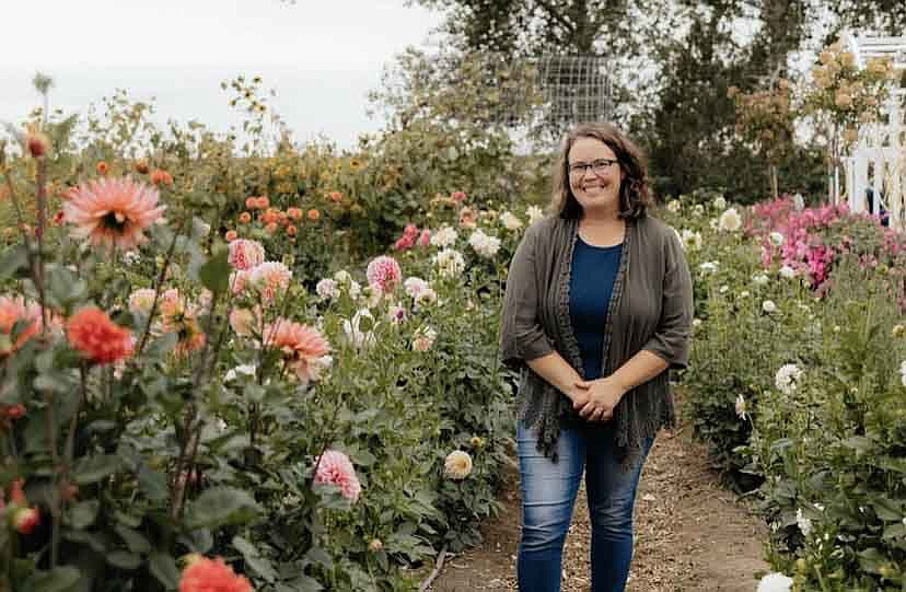 Nursery owner and dahlia buff Valerie Parrott stands in front of her dahlia garden. Parrott is offering a free tour with tips on growing the beautiful blooms on Monday.