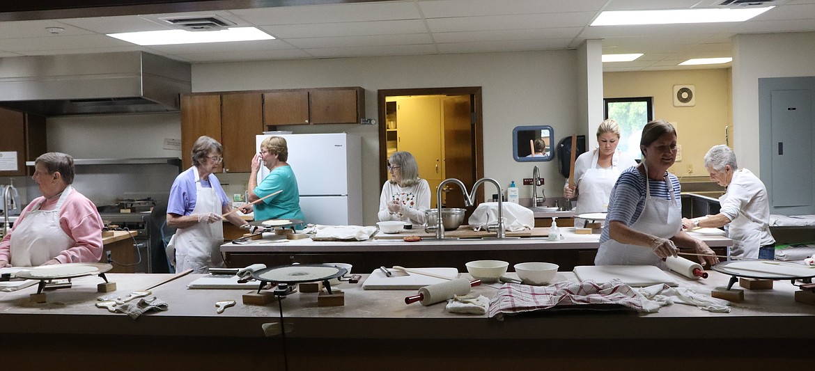 Volunteers make lefse in the kitchen at Trinity Lutheran Church on Wednesday