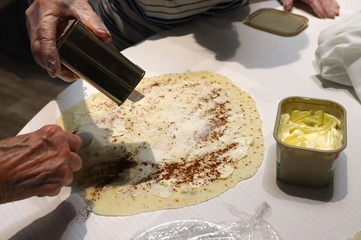 Butter, cinnamon and sugar are added to lefse for a sample tasting at Trinity Lutheran Church on Wednesday.