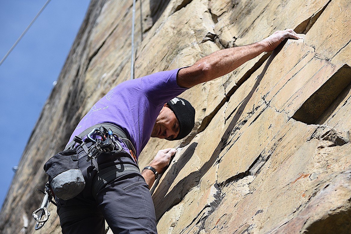 Columbia Falls' Greg Stenger analyzes his next step at the Stone Hill Climbing Area on Highway 37 south of Eureka at the Koocanusa Krank on Saturday, Sept. 23. (Scott Shindledecker/The Western News)