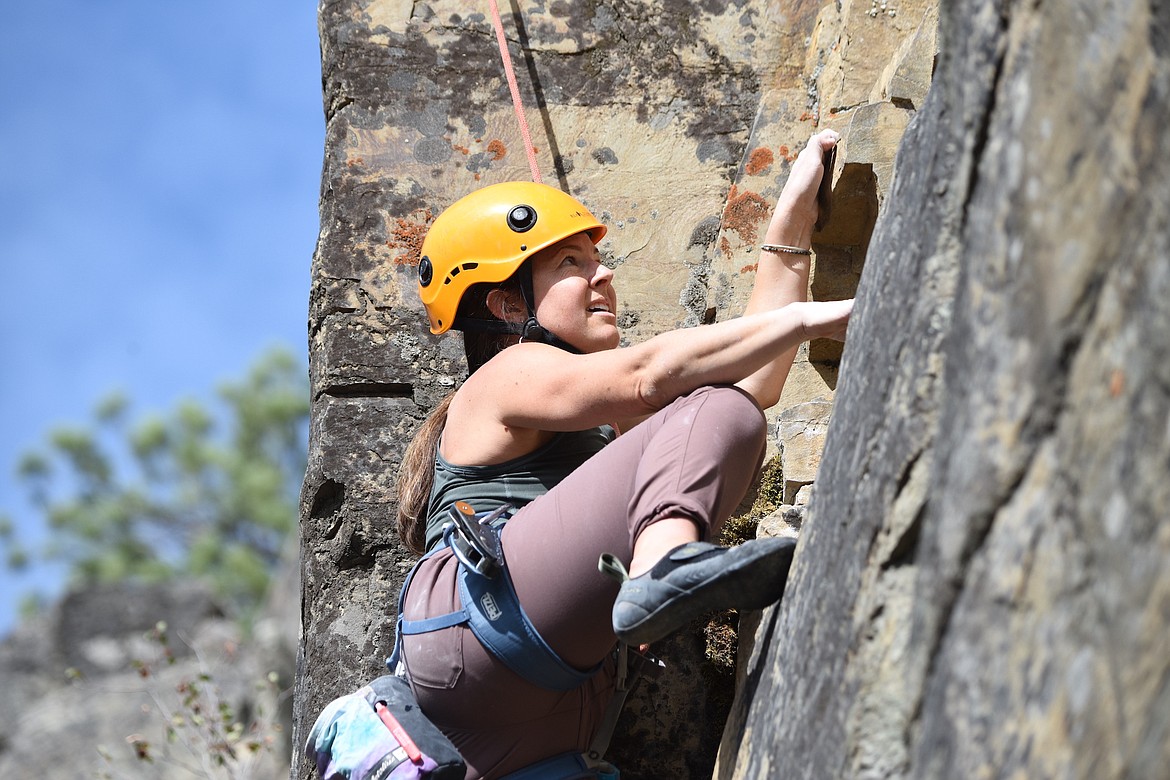 Whitefish's Julie Nissi eyes her next hand hold on a rock face at the Stone Hill Climbing Area on Highway 37 south of Eureka during the Koocanusa Krank on Saturday, Sept. 23. (Scott Shindledecker/The Western News)