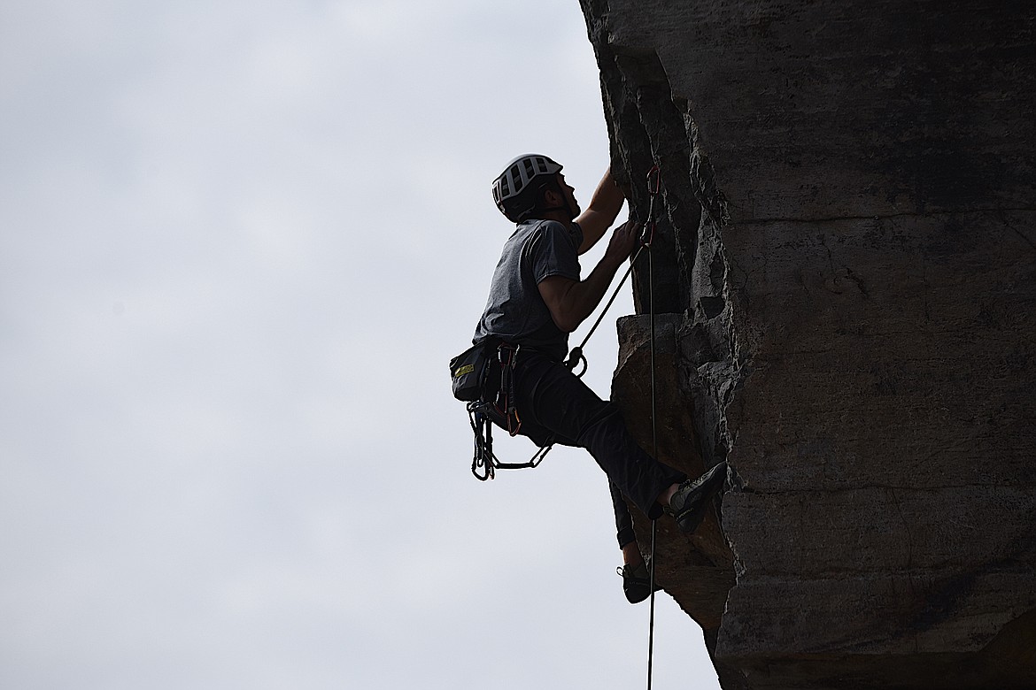 Whitefish's Sam Bourret works his way up a rock face at the Koocanusa Krank at the Stone Hill Climbing Area on Highway 37 south of Eureka on Saturday, Sept. 23. (Scott Shindledecker/The Western News)