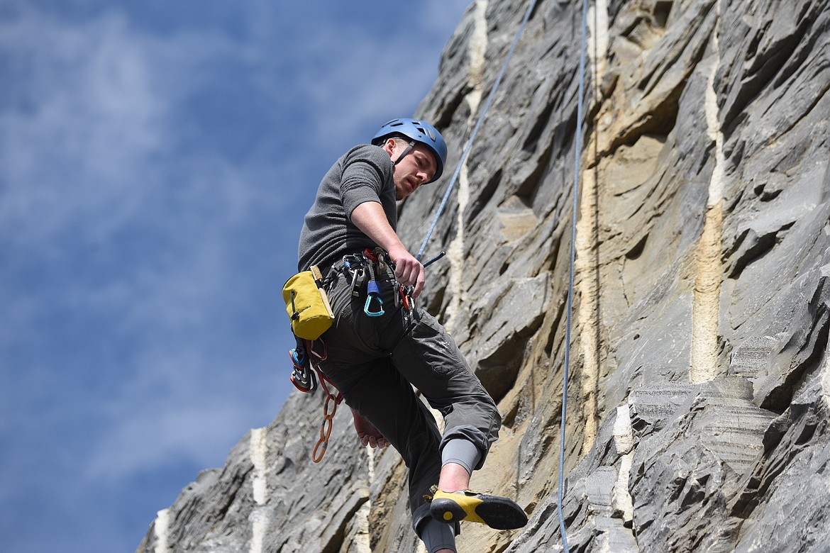 Helena's Tim Schmidt hangs out on a rock face at the Koocanusa Krank at the Stone Hill Climbing Area on Highway 37 south of Eureka on Saturday, Sept. 23. (Scott Shindledecker/The Western News)