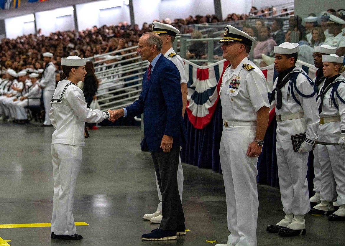 Retired Adm. Jonathan Greenert awards the Navy League Award to Seaman Apprentice Kiahna Kirk from Coeur d'Alene during Recruit Training Command's Pass-In-Review in Midway Ceremonial Drill Hall September, 22, 2023. More than 40,000 recruits train annually at the Navy's only boot camp.(U.S. Navy photo by Mass Communication Specialist 2nd Class Stuart Posada)