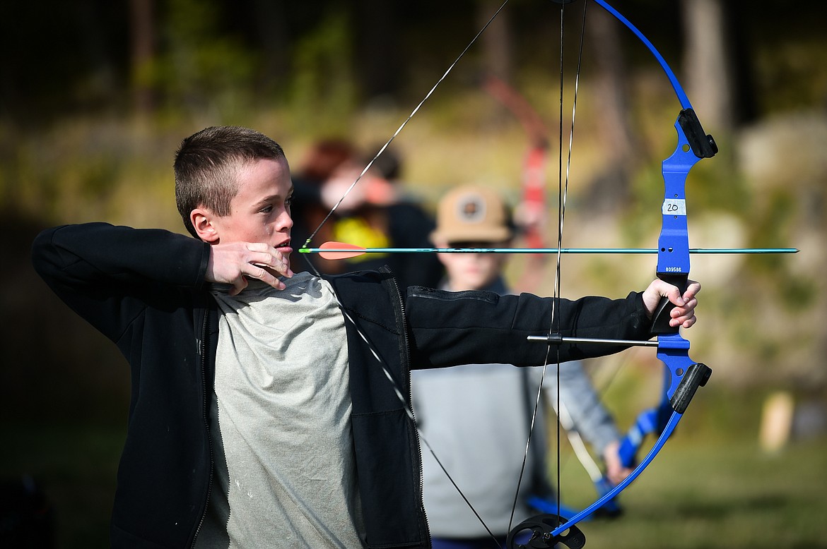 Seventh-grader Sean Thomas releases an arrow at a target during an archery lesson at Kila School's Native American Heritage Day in Kila on Friday, Sept. 29. (Casey Kreider/Daily Inter Lake)