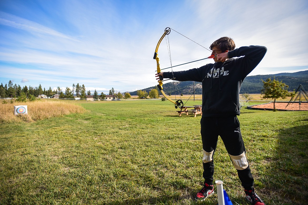 Eighth-grader Kaden Mathiason takes aim at a target during an archery lesson at Kila School's Native American Heritage Day in Kila on Friday, Sept. 29. (Casey Kreider/Daily Inter Lake)