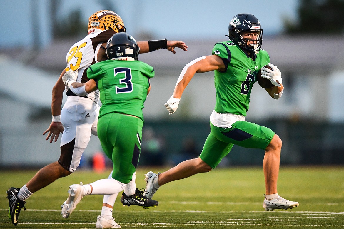 Glacier wide receiver Evan Barnes (8) picks up yardage on a run in the first quarter against Helena Capital at Legends Stadium on Friday, Sept. 29. (Casey Kreider/Daily Inter Lake)