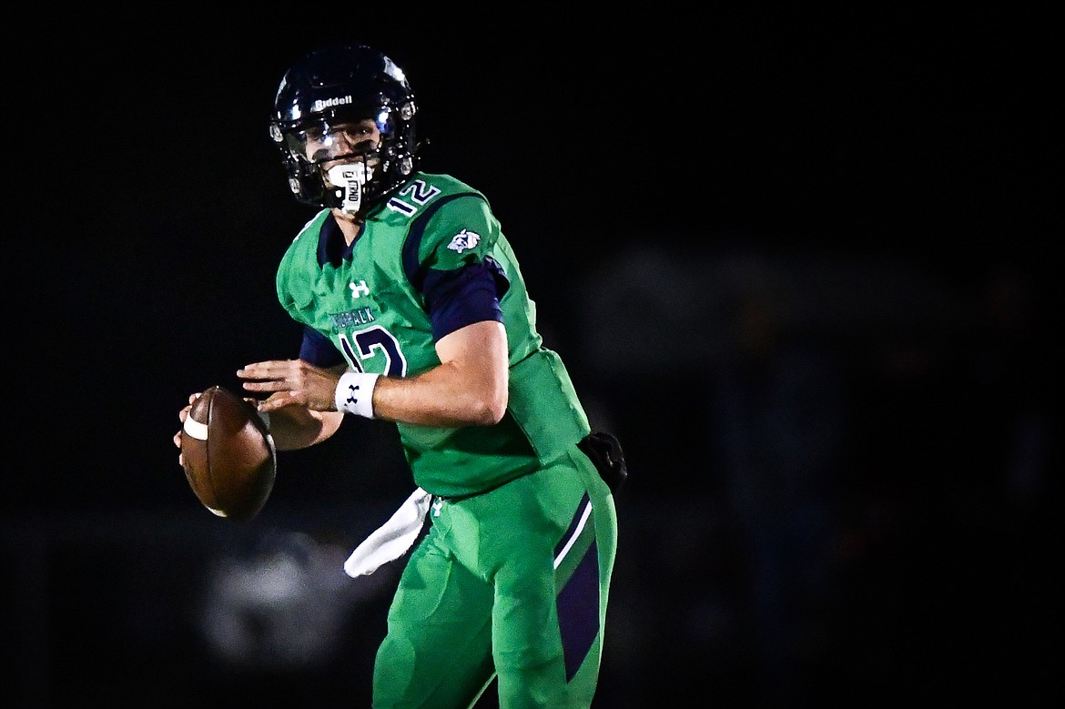 Glacier quarterback Jackson Presley (12) rolls out to pass in the second quarter against Helena Capital at Legends Stadium on Friday, Sept. 29. (Casey Kreider/Daily Inter Lake)